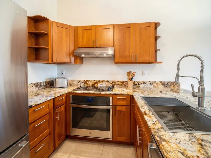 Kitchen remodel Maui by Great General LLC — cherry wood cabinets and granite countertops