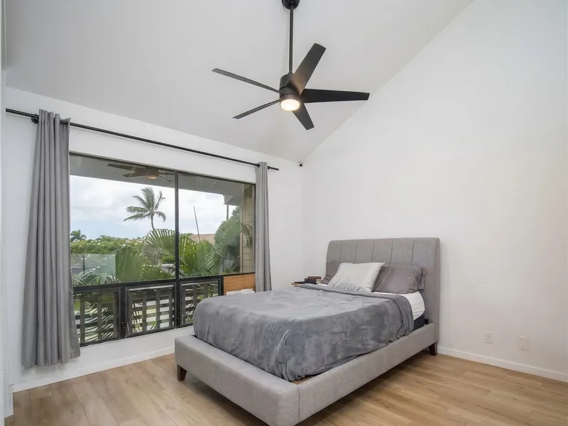 Bedroom remodel Maui — vaulted ceiling, new LVP flooring and sliding glass to garden balcony