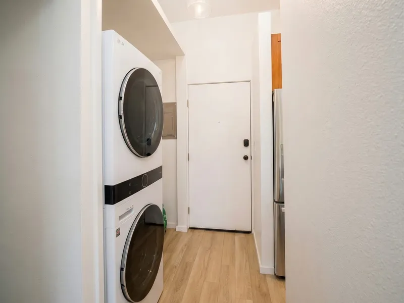 Interior remodel Maui — laundry buildout with stacked LG units and LVP flooring