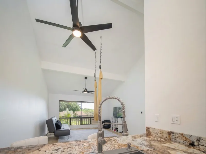 Kitchen to living room open plan remodel Maui by Great General LLC — granite counters and vaulted ceilings