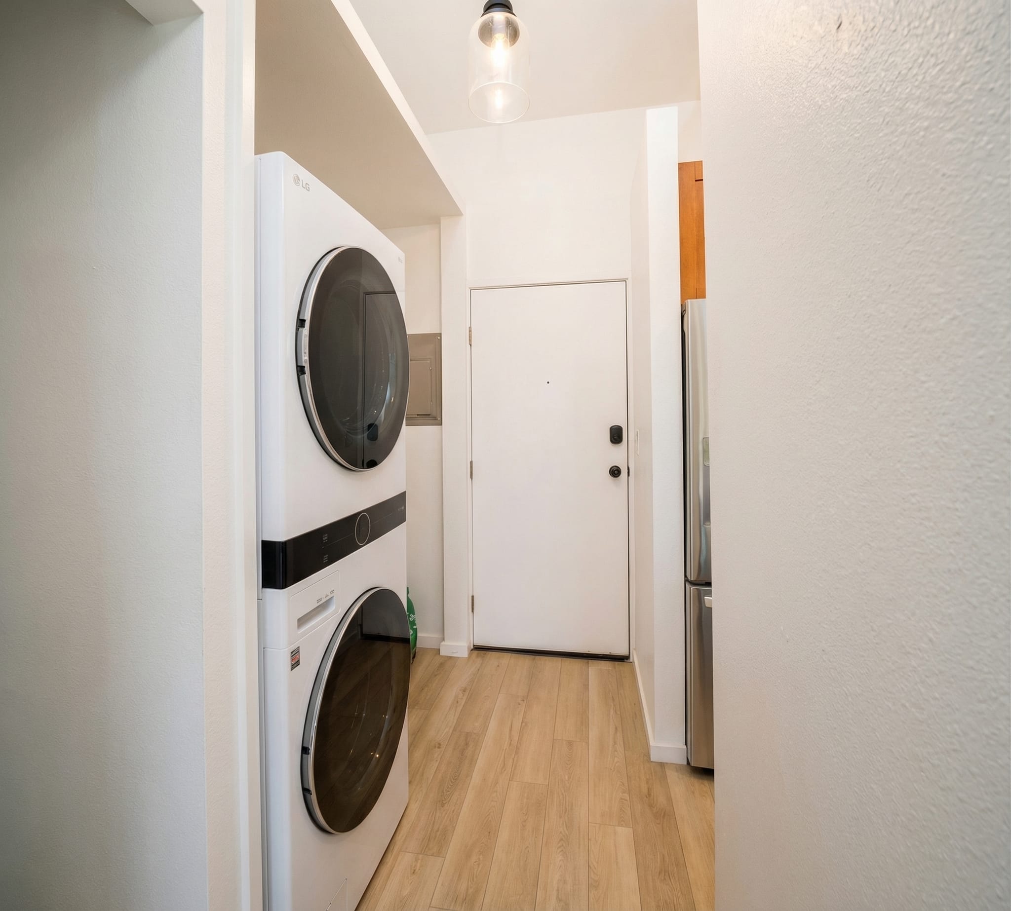 Interior remodel Maui — laundry buildout with stacked LG units and LVP flooring
